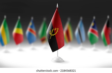 The national flag of the Angola on the background of flags of other countries