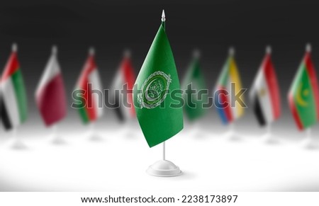 The national flag of the Arab League on the background of flags of other countries