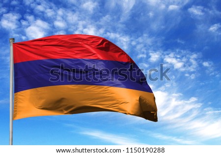 National flag of Armenia on a flagpole in front of blue sky