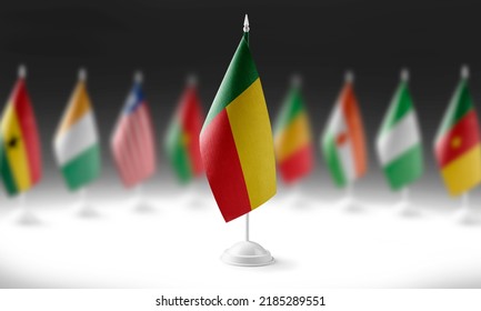 The national flag of the Benin on the background of flags of other countries