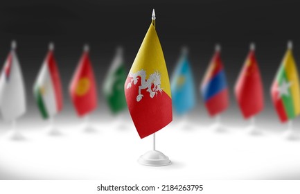 The national flag of the Bhutan on the background of flags of other countries