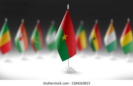 The national flag of the Burkina Faso on the background of flags of other countries