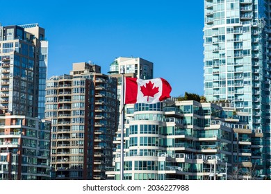 National Flag Of Canada With Downtown Vancouver City Condominium Apartment In The Background. Concept Of Canadian Urban City Life.