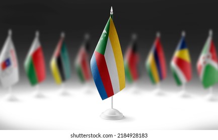 The national flag of the Comoros on the background of flags of other countries