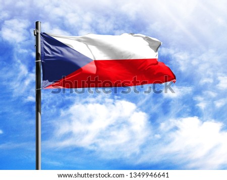 National flag of Czech Republic on a flagpole in front of blue sky.
