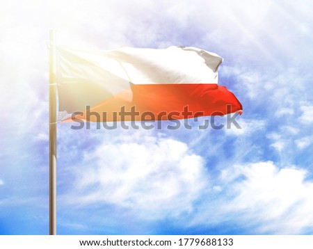 National flag of Czech Republic on a flagpole in front of blue sky