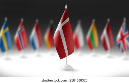 The national flag of the Denmark on the background of flags of other countries