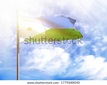 National flag of Djibouti on a flagpole in front of blue sky