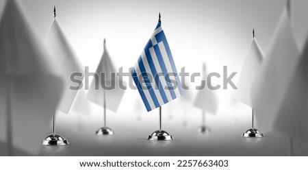 The national flag of the Greece surrounded by white flags.