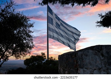 The national flag of Greece is waving in the clear blue Greek sky. The white cross symbolises Eastern Orthodox Christianity, the prevailing religion of Greece. - Powered by Shutterstock