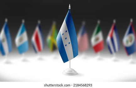 The national flag of the Honduras on the background of flags of other countries