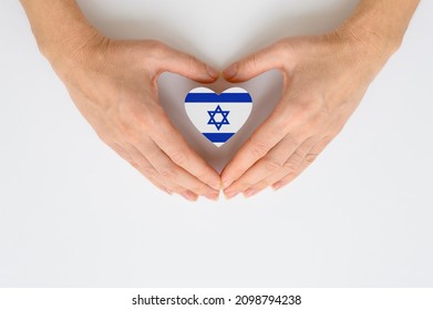 The national flag of Israel in female hands. The concept of patriotism, respect and solidarity with the citizens of Israel. - Shutterstock ID 2098794238
