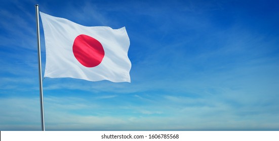 The National flag of Japan blowing in the wind in front of a clear blue sky. 3d illustration.