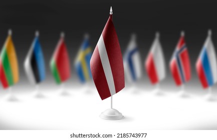 The national flag of the Latvia on the background of flags of other countries