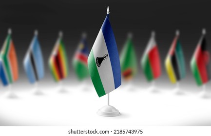 The national flag of the Lesotho on the background of flags of other countries