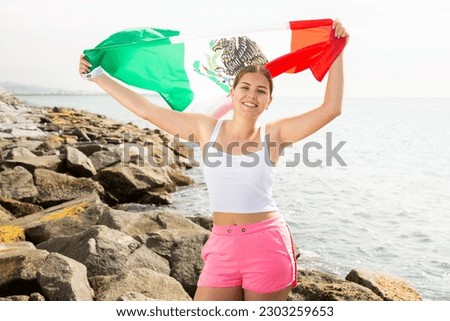 National flag of Mexico. Beautiful woman with Mexico flag on the beach