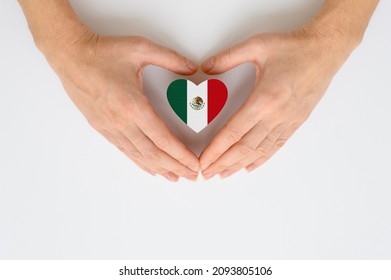 The national flag of Mexico in female hands. The concept of patriotism, respect and solidarity with the citizens of Mexico. - Shutterstock ID 2093805106