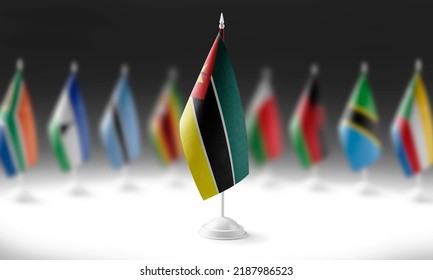 The national flag of the Mozambique on the background of flags of other countries