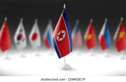 The national flag of the North Korea on the background of flags of other countries