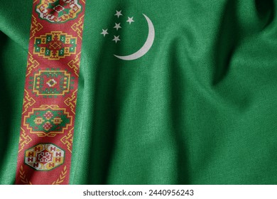 National Flag on Textured Fabric Background. Silk textured flag, realistic wave and flag look. TM  Flag of Turkmenistan