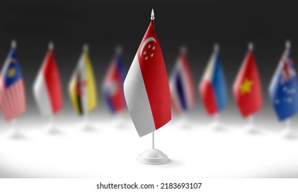 The national flag of the Singapore on the background of flags of other countries