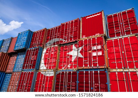 The national flag of Turkey on a large number of metal containers for storing goods stacked in rows on top of each other. Conception of storage of goods by importers, exporters