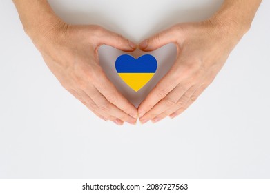 The national flag of Ukraine in female hands. The concept of patriotism, respect and solidarity with the citizens of Ukraine. - Shutterstock ID 2089727563