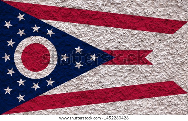 The national flag of the US state Ohio in\
against a gray wall with stony surface on the day of independence\
in colors of blue red and white. Political and religious disputes,\
customs and delivery.