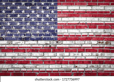 National flag of USA depicting in paint colors on an old brick wall. Flag  banner on brick wall background.