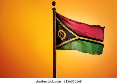 The national flag of Vanuatu on a flagpole isolated on an orange background