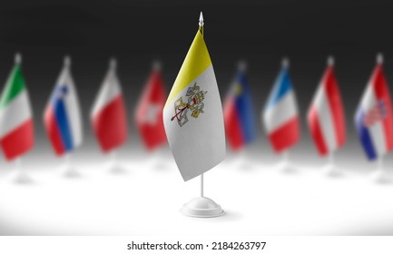 The national flag of the Vatican on the background of flags of other countries