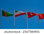 National flags of Turkmenistan, Iran, Turkey, China swaying in wind on clear blue sky. Negotiations, diplomatic visit, meeting guests, friendship peoples, trade between countries, signing of treaties.