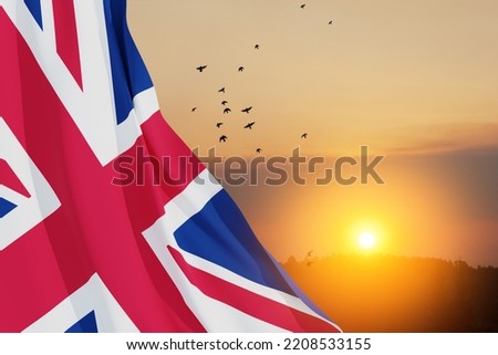 National flags of United Kingdom with flying birds on sunset sky background. Background with place for your text. 3d rendering.