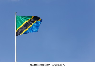 The national fllag of Tanzania on blue sky.