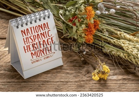 National Hispanic Heritage Month (September 15 - October 15) - note in a desktop calendar with floral fall bouquet, reminder of cultural event