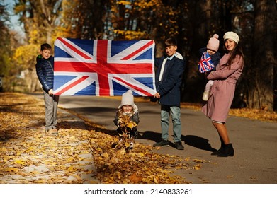 National Holiday Of United Kingdom. Family With British Flags In Autumn Park.  Britishness Celebrating UK. Mother With Four Kids.