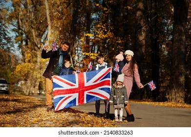 National Holiday Of United Kingdom. Large Family With Four Kids Holding British Flags In Autumn Park.  Britishness Celebrating UK.