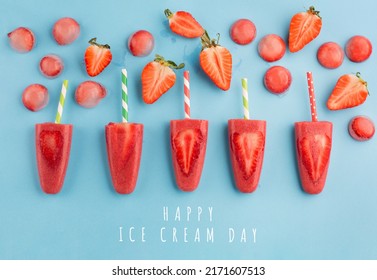 National ice cream day, july 17, summertime holiday concept. Homemade strawberry popsicles with fresh slices on blue background, top view, copy space. 