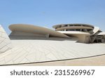 National Museum of Qatar and aircraft taking off above - Doha, Qatar