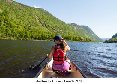 Hautes-gorges-de-la-rivière-Malbaie National Park, Canada - June 2020 : Back View Of A Young Woman Canoeing On The Malbaie River