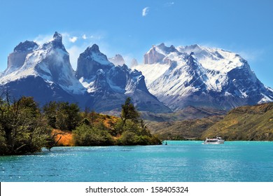  National Park Torres del Paine, Chile.  Azure Lake Pehoe at the foot of the magnificent snow-covered cliffs of Los Kuernos