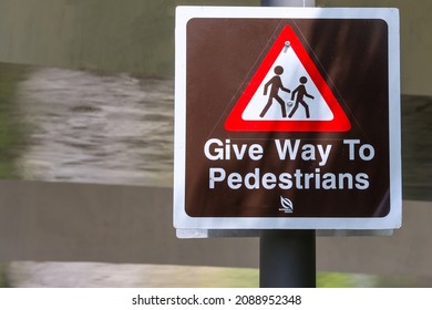 A National Parks signboard "Give Way To Pedestrians" on a Punggol cycling path or park connector which get about 90 serious accidents (result in injuries, fatalities) involving cyclists yearly