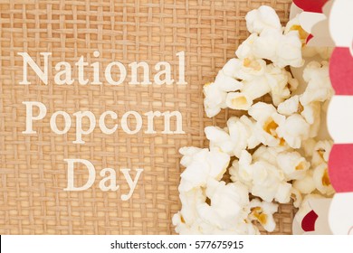 National Popcorn Day message, A popcorn container and popcorn with text National Popcorn Day - Powered by Shutterstock