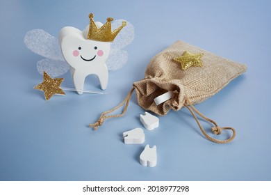 National Tooth Fairy Day. Children tooth fairy. Cute tooth with wings, a crown and a magic wand and bag with teeth.