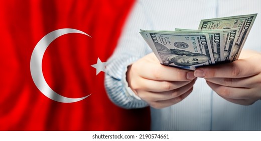 National Turkish Flag And US Dollars In Hands. Business, Tax, Banking And Finance Concept