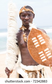 native african man with traditional clothing on beach