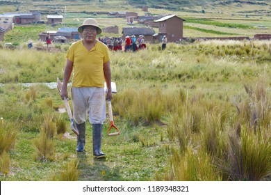 Native American Farmer Holding Tools In The Countryside.