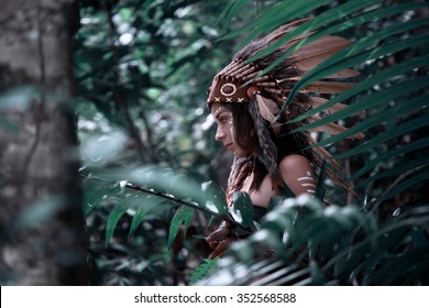 Native American, Indian Woman In Traditional Dress,posing In The Wild Forest