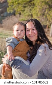 Native American Mother And Baby Boy Outdoors In Nature