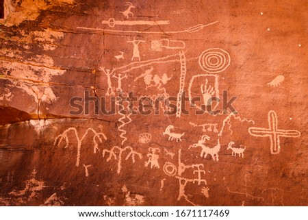 Native American petroglyphs - art drawings, estimated to be over 4000 years old, at Atlatl Rock, Valley of Fire State Park, Nevada, USA